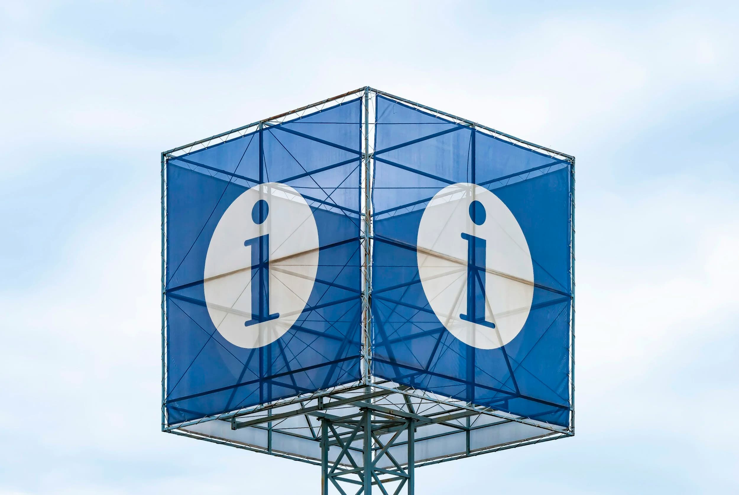 sign that depicts a large letter i on a blue background