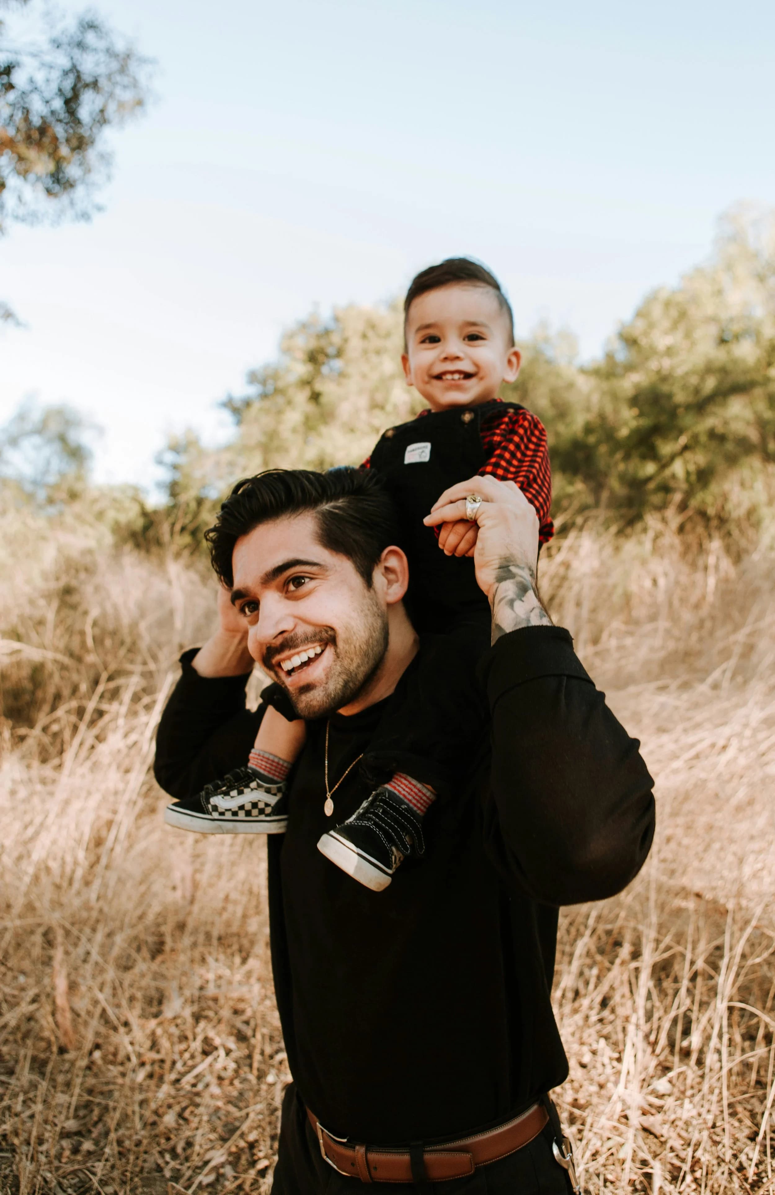 A dad walking with a toddler on his shoulders